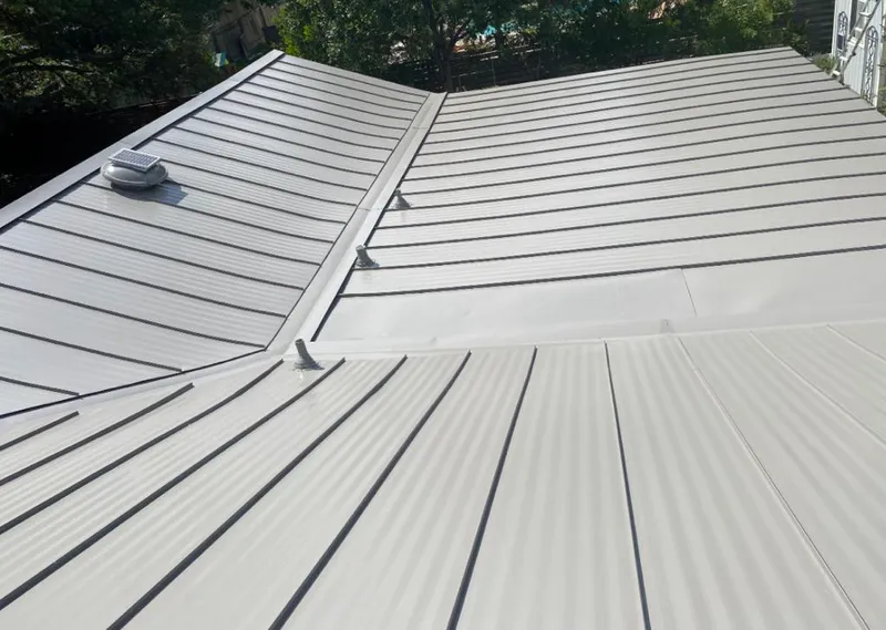 Solar attic fan installed on a metal roof for Roof Ventilation in Woburn